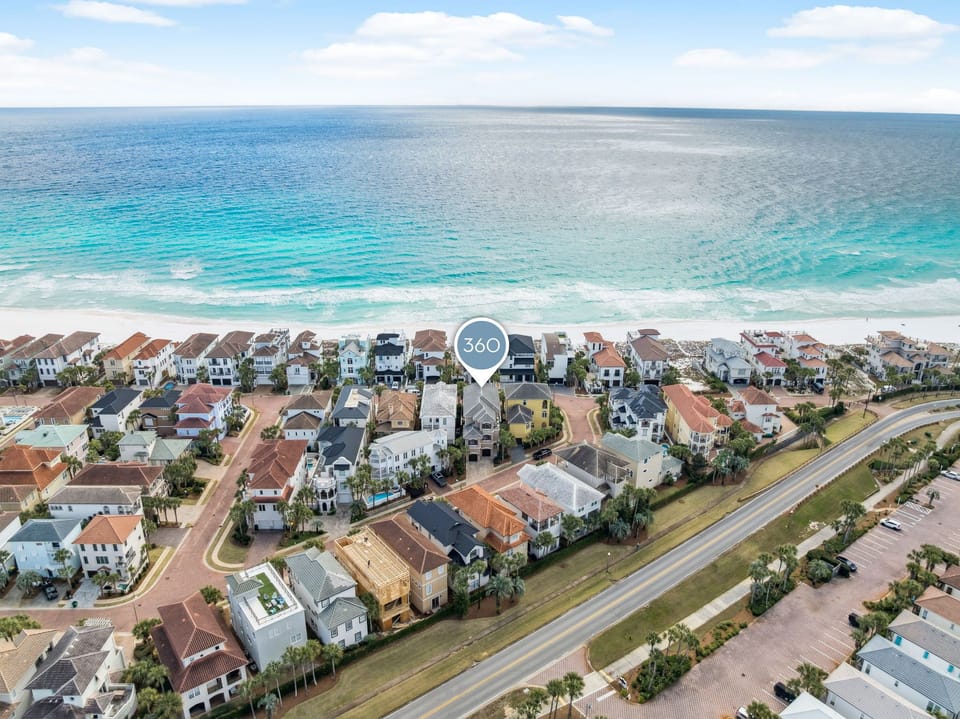 Stunning beachfront community with crystal-clear turquoise waters and pristine white sand just steps from elegant coastal homes.