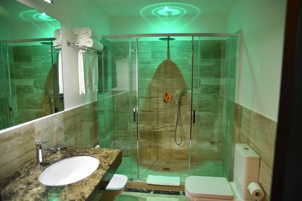 Exclusive Double Room, Balcony, City View | Bathroom | Shower, rainfall showerhead, free toiletries, hair dryer