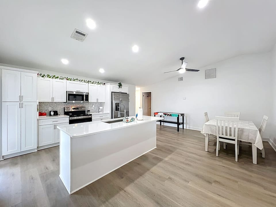 Fully equipped kitchen featuring our signature Espresso Bar | dishwasher, oven, microwave, Fridge, Silverware, Pans pots, cups, dishes, seasonings, filtered water in fridge, coffee machine, espresso machine and coffee provided, toaster.