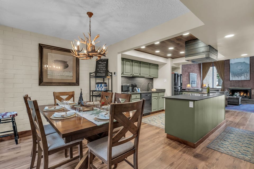 Dining area and kitchen: Antler chandelier, seating for 6, updated appliances, rustic charm
