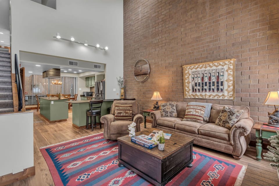 Living room: Plush seating, gas fireplace, vaulted ceiling, rustic decor
