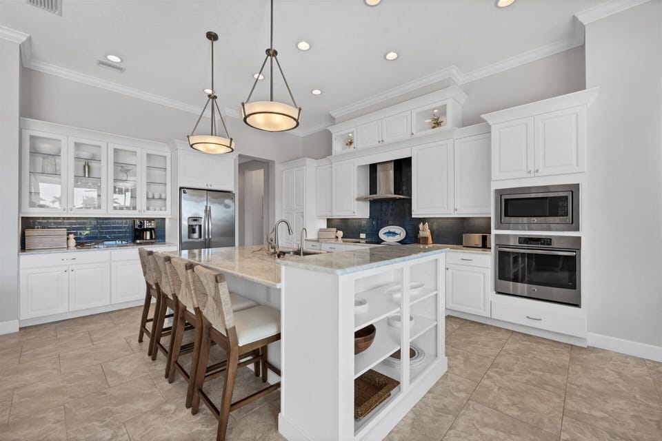 Gorgeous, fully-equipped kitchen over looking the living room and dining areas. Kitchen features lots of countertop & storage space, and stainless-steel appliances. Kitchen island seats 4
