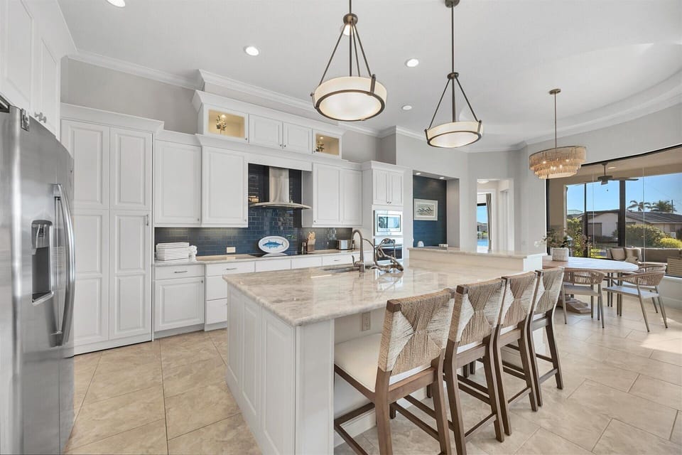 Gorgeous, fully-equipped kitchen over looking the living room and dining areas. Kitchen features lots of countertop & storage space, and stainless-steel appliances. Kitchen island seats 4