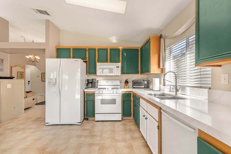 Spacious U-shaped kitchen with ample countertop space for meal prep.