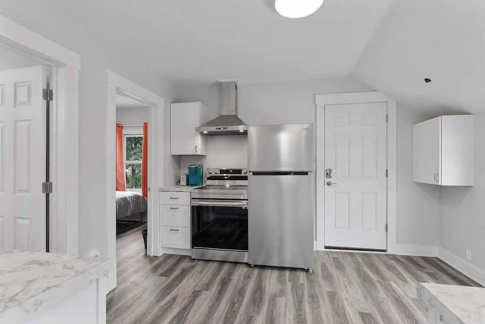 Kitchen features stainless steel appliances with a glass stop stove and a coffee bar. The twin bedroom is off the kitchen along with the bathroom. 