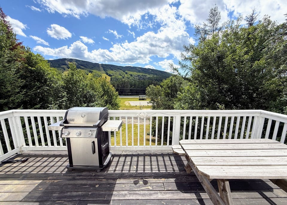 The upper level deck offers a gas grill and picnic table with views of the Bretton Woods Ski Area