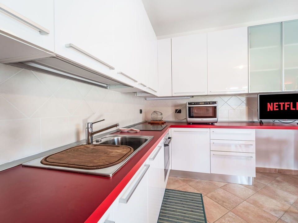 Kitchen, Kitchen Appliance, Major Appliance, Countertop, Flooring, Interior Design, Cabinetry, Floor, Kitchen Stove, Home Appliance