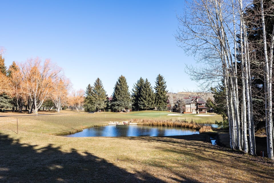 Peaceful open views of the nearby golf course and pond, framed by mature trees. A relaxing spot for a stroll, morning coffee outside, or soaking in the mountain scenery.