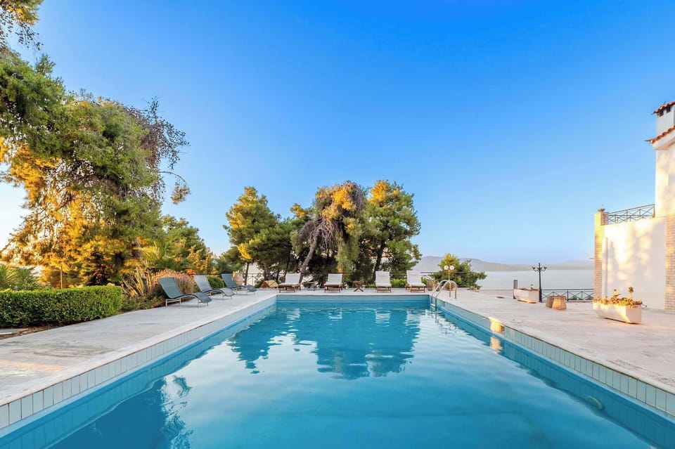 Sunset Pool Terrace with Panoramic Sea Views and Lush Garden