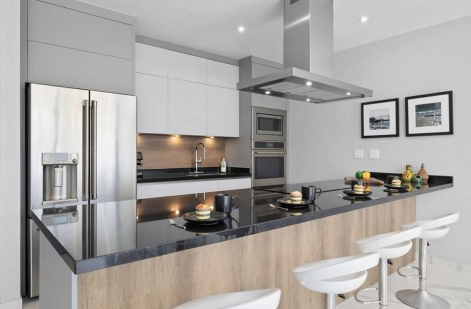 Fully equipped modern kitchen with bar seating — perfect for quick breakfasts, coffee, or cooking meals during your stay.