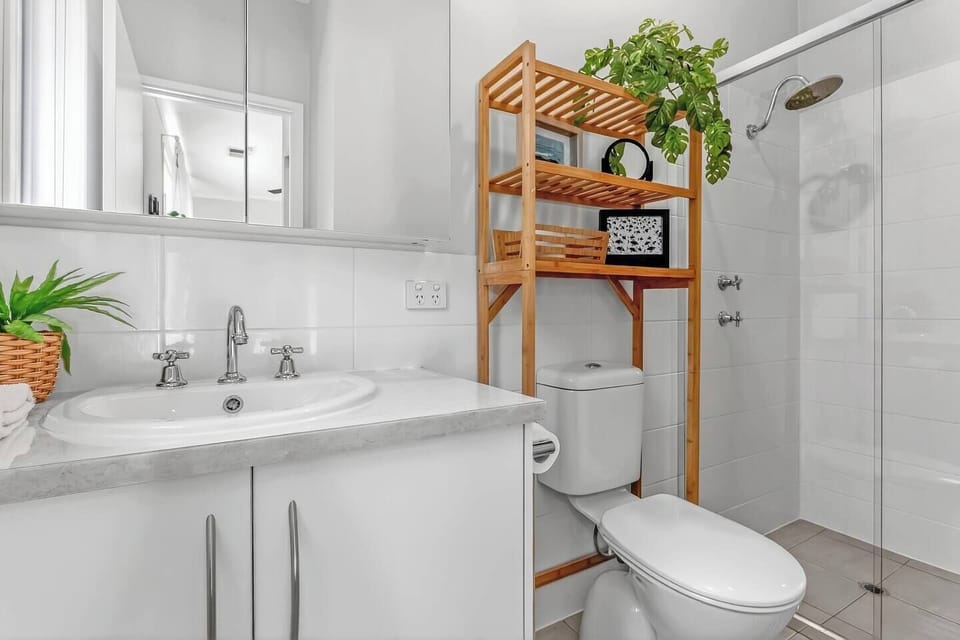 The ensuite bathroom combines clean, modern finishes with a walk-in shower designed to refresh you after long beach days.