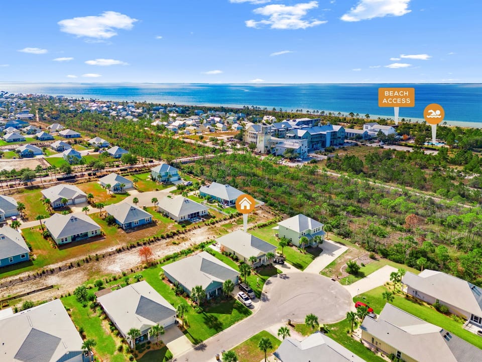 Aerial view of coastal vacation rental community with direct beach access and beautiful oceanfront location.