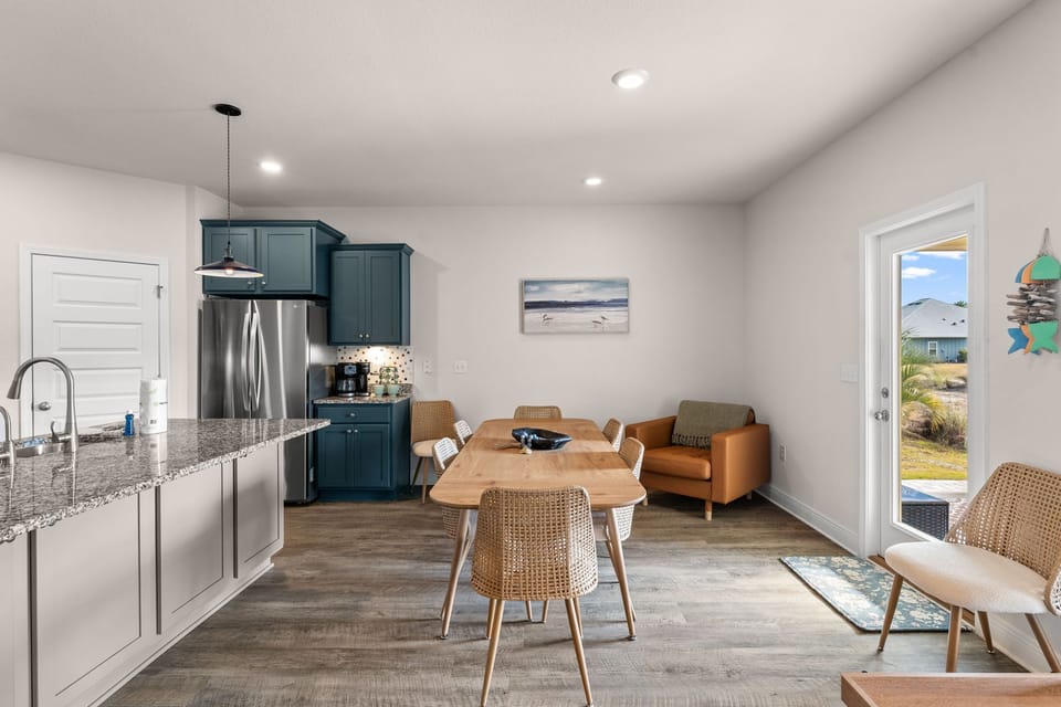 Step into your stylish open-concept space where modern kitchen meets cozy dining area, perfect for memorable meals together.