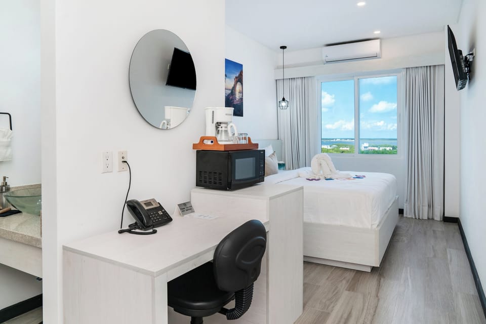 Room has desk, mini fridge, microwave, coffee pot