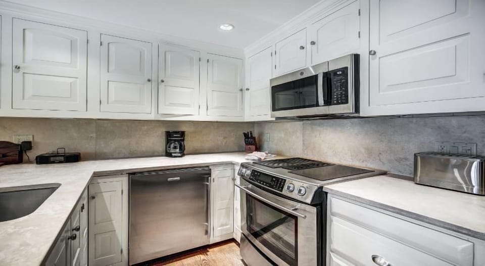 The elegant kitchen features modern appliances and a pristine design, blending functionality with mountain-chic aesthetics.