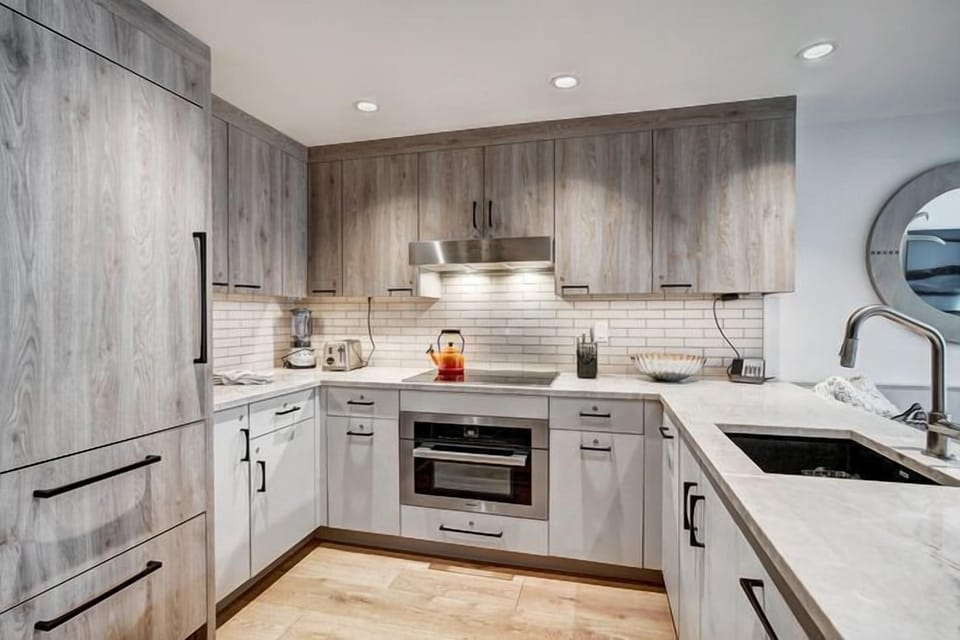 This modern kitchen features sleek cabinetry and high-end appliances, perfect for preparing gourmet meals after a day on the slopes.