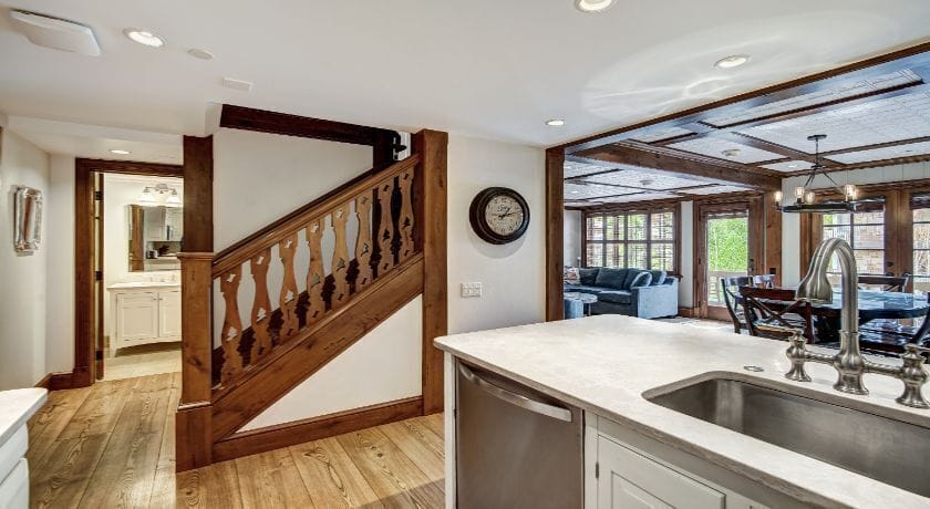 The charming entryway leads to an open living space filled with natural light, showcasing the beautiful wooden details and inviting atmosphere.