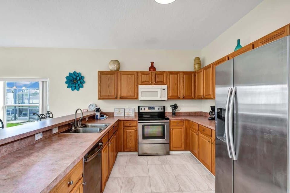 Fully equipped kitchen with stainless-steel appliances and everything needed for home-cooked meals.