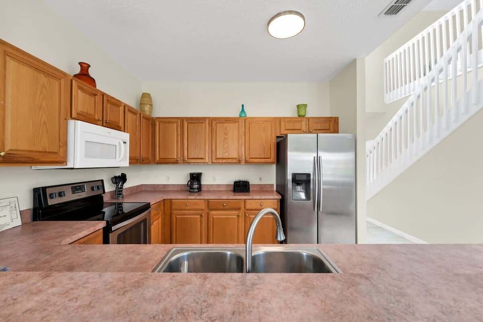 Fully equipped kitchen with stainless-steel appliances and everything needed for home-cooked meals.