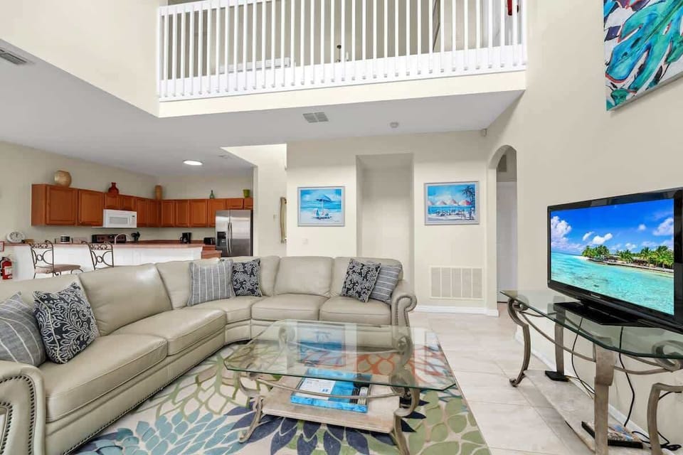Bright and spacious living area with cozy seating and a smart TV for relaxing evenings.