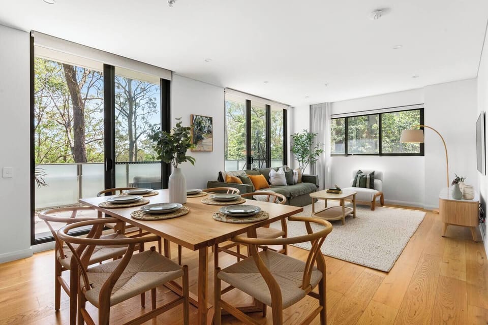Gather at the six-seater dining table where warm styling and leafy outlooks set the scene for shared moments.