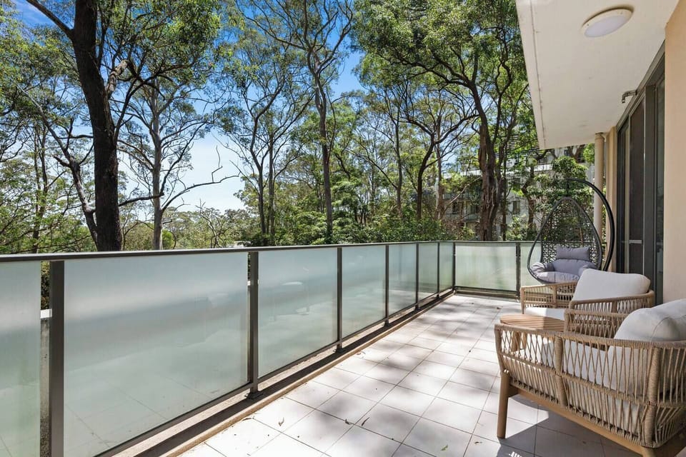 Step onto the private balcony furnished with lounge chairs and a hanging egg chair, ideal for unwinding with hillside sunsets and quiet treetop vistas.