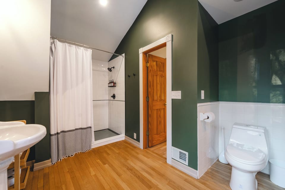 The primary suite bathroom has a large shower for guests to enjoy