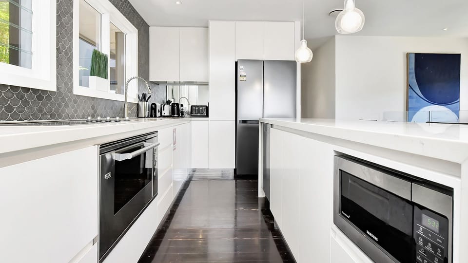 Modern kitchen: built-in oven and generous bench space.