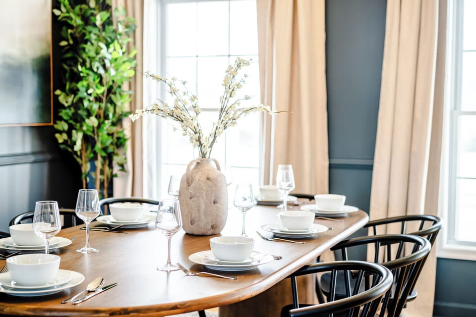 Dining room with floor-to-ceiling windows framing the mountains. Every meal has a view.