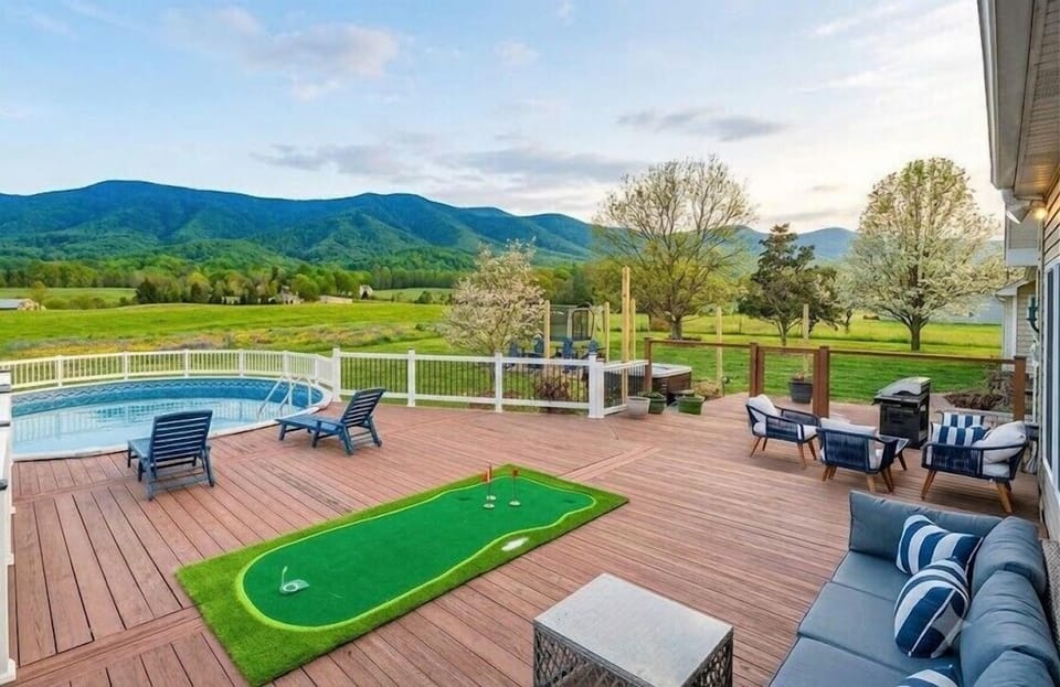 Deck life: pool, putting green, mountain panorama. Loungers facing the view. If you close your eyes you can hear the splashing.