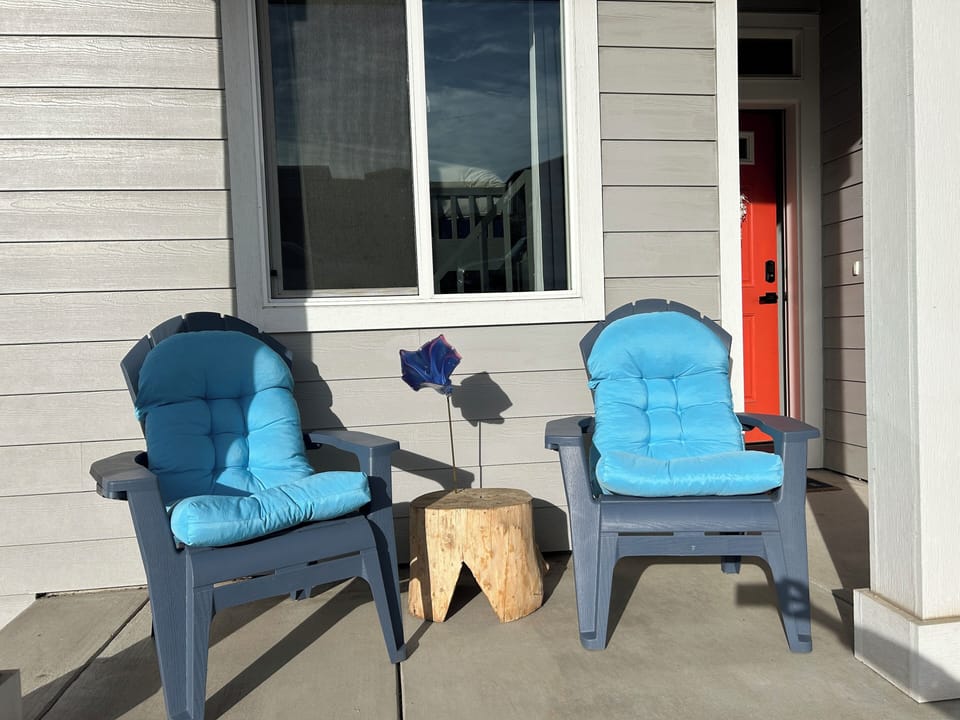 Your sunny morning porch for coffee. Local glass blown art flower.