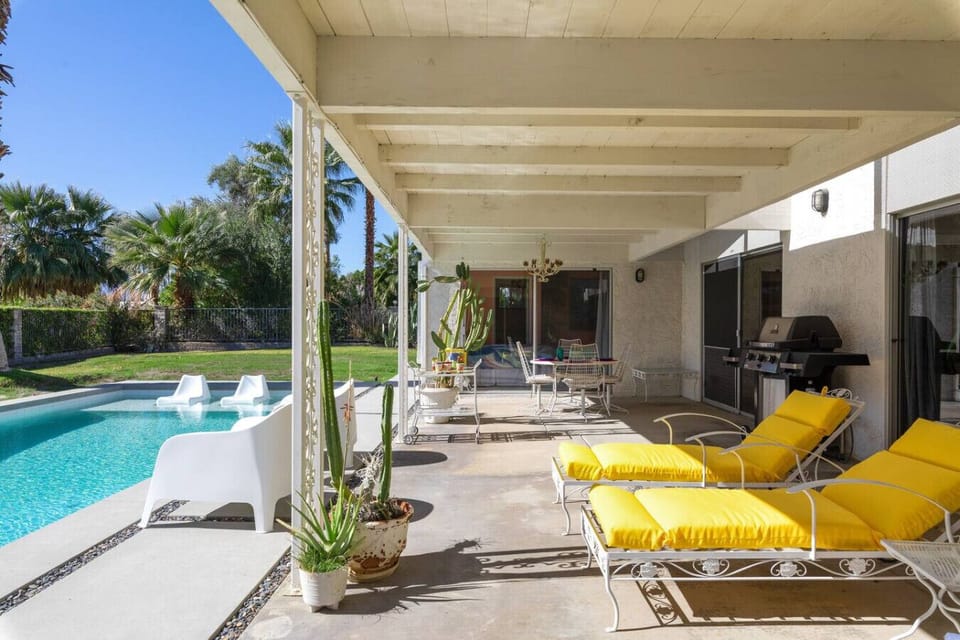 The backyard is perfect for relaxing days or evening dinners, and includes a gas grill, misters, and plenty of seating for 10-12.