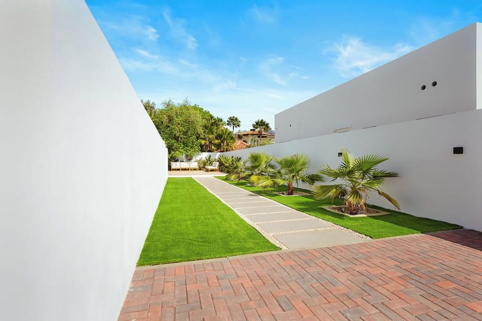 Step away from the noise and into serenity. This is where clean lines and lush greenery meet under a perfect blue sky. Imagine sipping your morning coffee or evening cocktail in this secluded paradise.