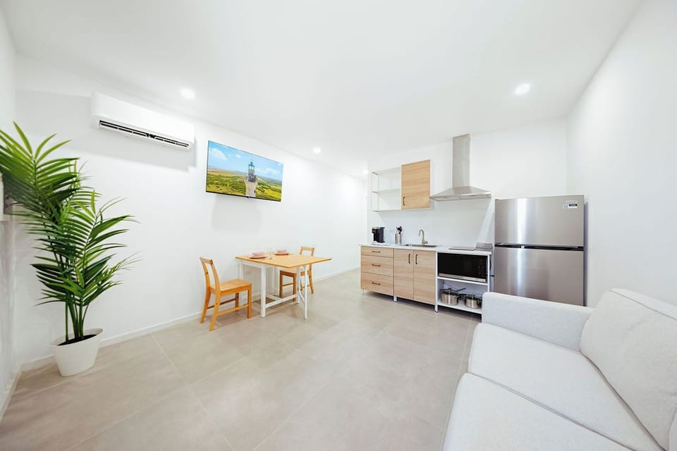 Your bright and modern escape awaits! This studio is designed for comfort and style, featuring clean lines, a cozy sofa for unwinding, and a smart dining setup. Perfect for weekend getaways or remote work.
