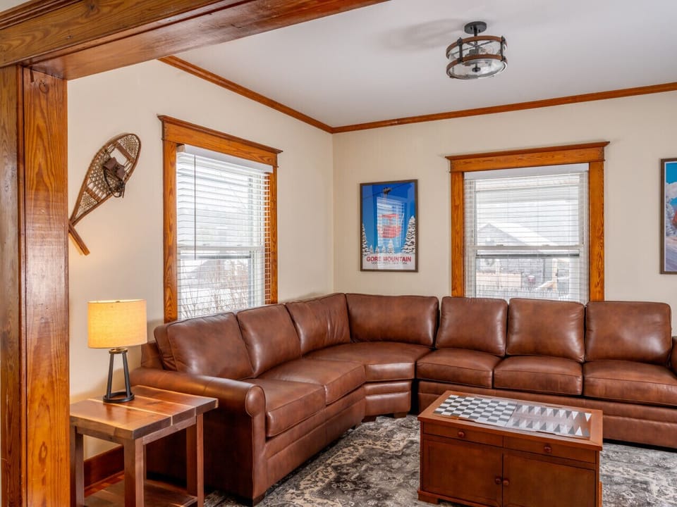 Living Room with leather couches, pull out queen size sofa bed, lots of games, and a television