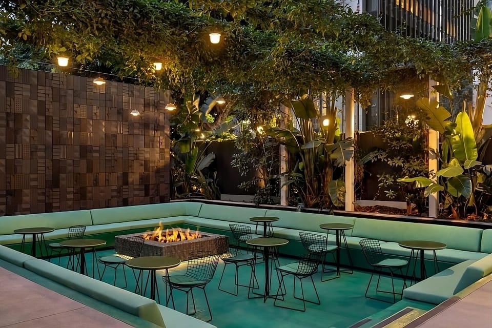 Sip cocktails around the courtyard firepit under twinkling lights.