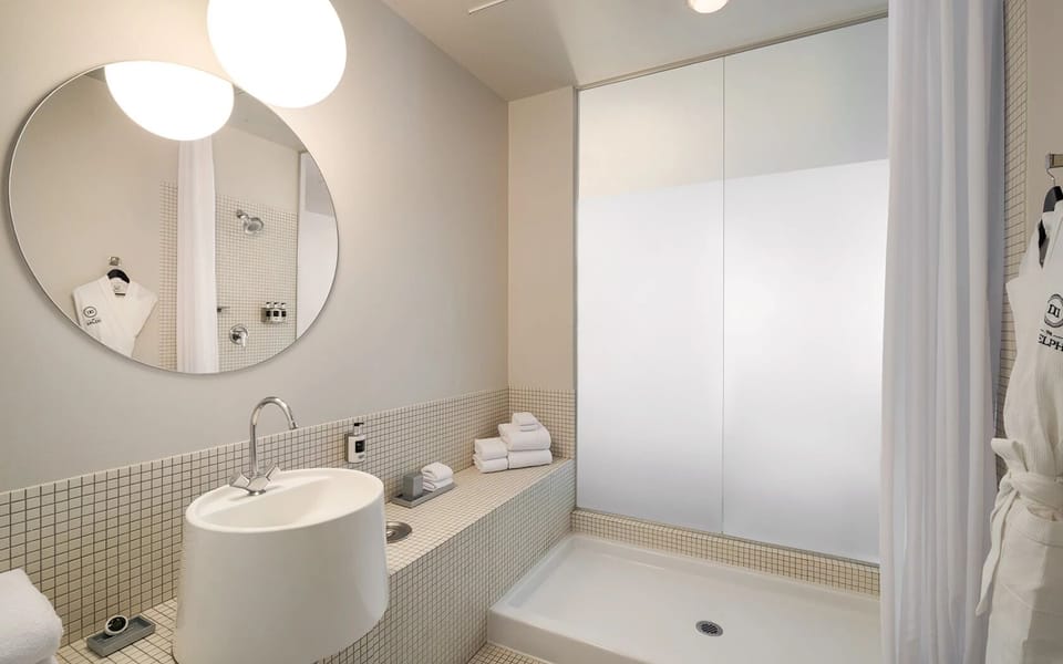 Refresh in a spotless bath with soft towels and bright lighting.