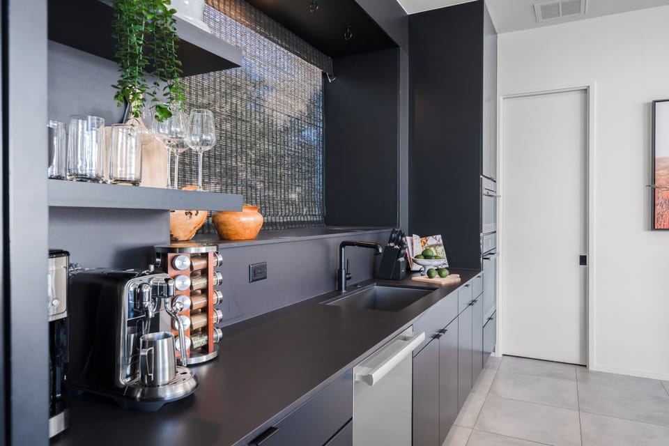 Detail shot of the black kitchen cabinetry and countertop.