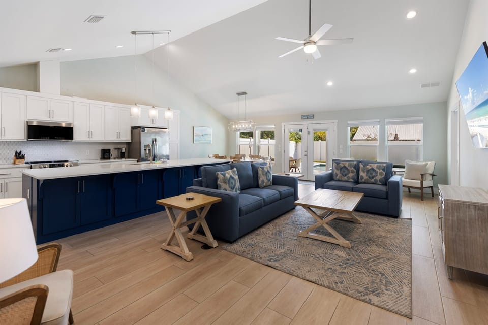 Unwind in your spacious open-concept living area where modern comfort meets coastal charm, perfect for gathering with loved ones.