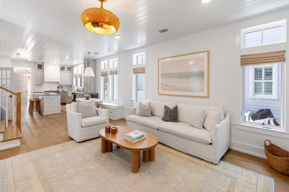 Sink into plush seating in this bright, airy living space where coastal charm meets modern comfort for your perfect getaway.