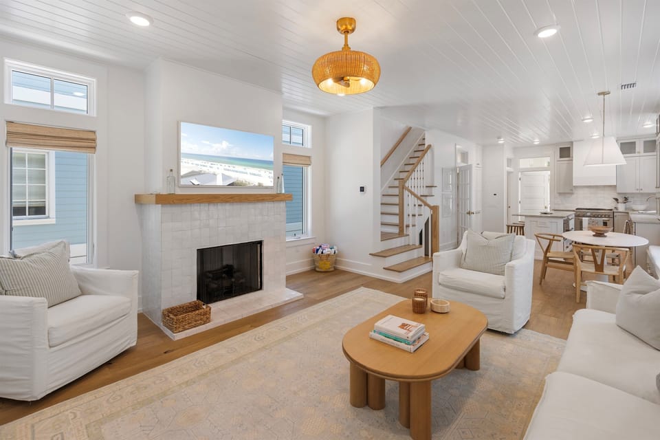 Unwind in your bright, airy living space with cozy fireplace, ocean views, and seamless flow to the modern kitchen.