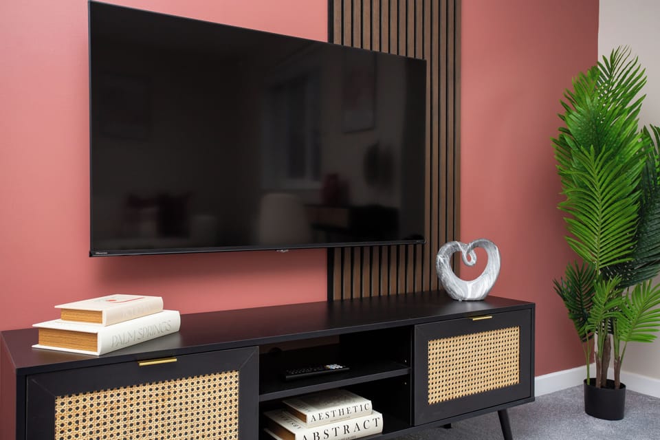Stylish media unit set against a modern feature wall.