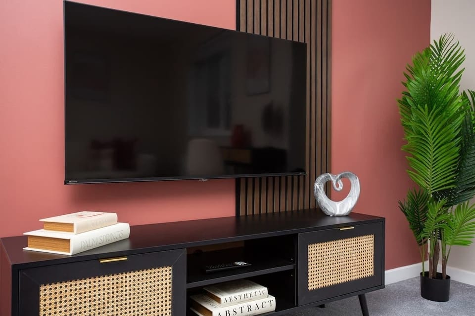 Stylish media unit set against a modern feature wall.