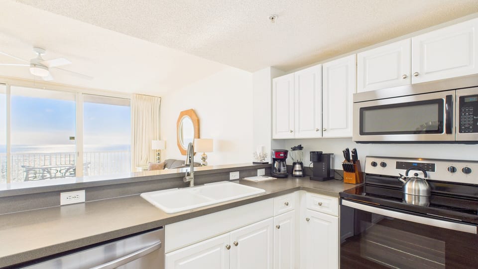 Your modern kitchen features updated appliances and a clean, functional layout ideal for preparing meals.