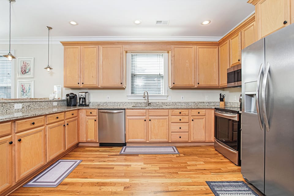 Your spacious kitchen features granite countertops, stainless steel appliances, and warm wood cabinets for memorable meal preparation.