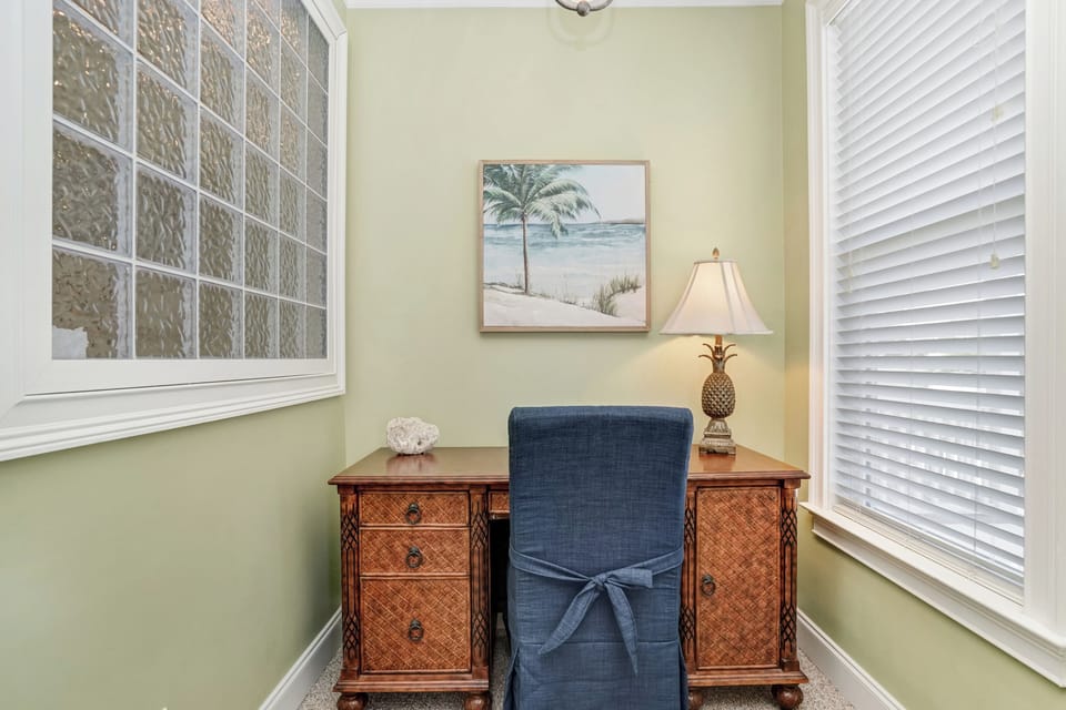 Your perfect work-from-paradise desk awaits with tropical art and warm lighting for productive mornings.