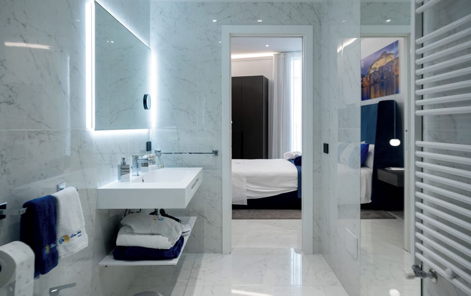 Quadruple Room, Balcony, City View | Bathroom | Hair dryer, bathrobes, slippers, bidet