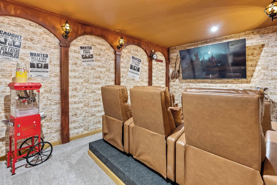 Experience the comfort of our cozy home theater with oversized leather chairs perfect for movie nights. The warm wooden arches and vintage decor create a nostalgic ambiance, making it the ideal place to relax and unwind.