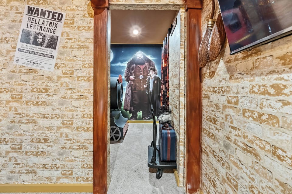 Step into a unique hallway that showcases rustic charm, with exposed brick walls and warm wood accents. The intriguing mural at the end hints at an adventurous theme, inviting curiosity and enhancing your stay.