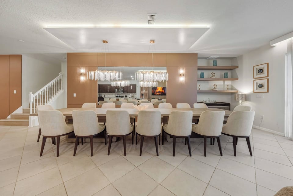 Gather around our spacious dining table with plush cream chairs that inspire great conversations. The warm wood accents, sleek cabinetry, and soft lighting create a sophisticated and inviting ambiance for you to enjoy.